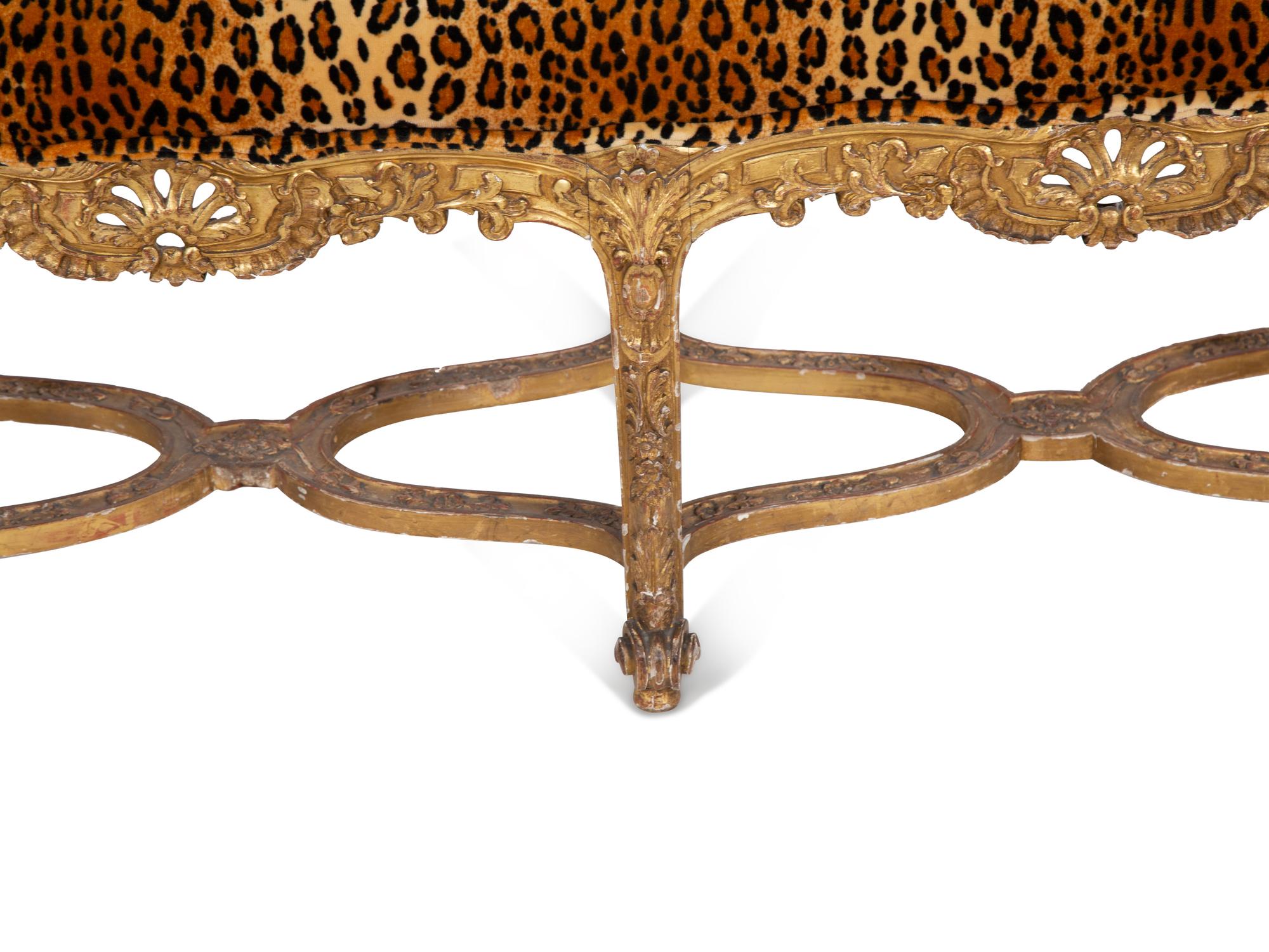 A Louis XV Style Giltwood Bench with Faux Leopard Upholstery