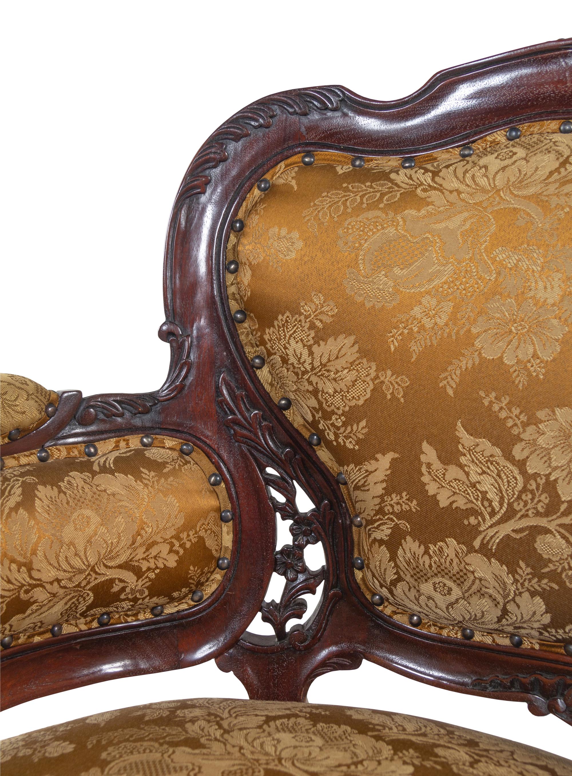 A Set of Four Rococo Style Upholstered Mahogany Armchairs