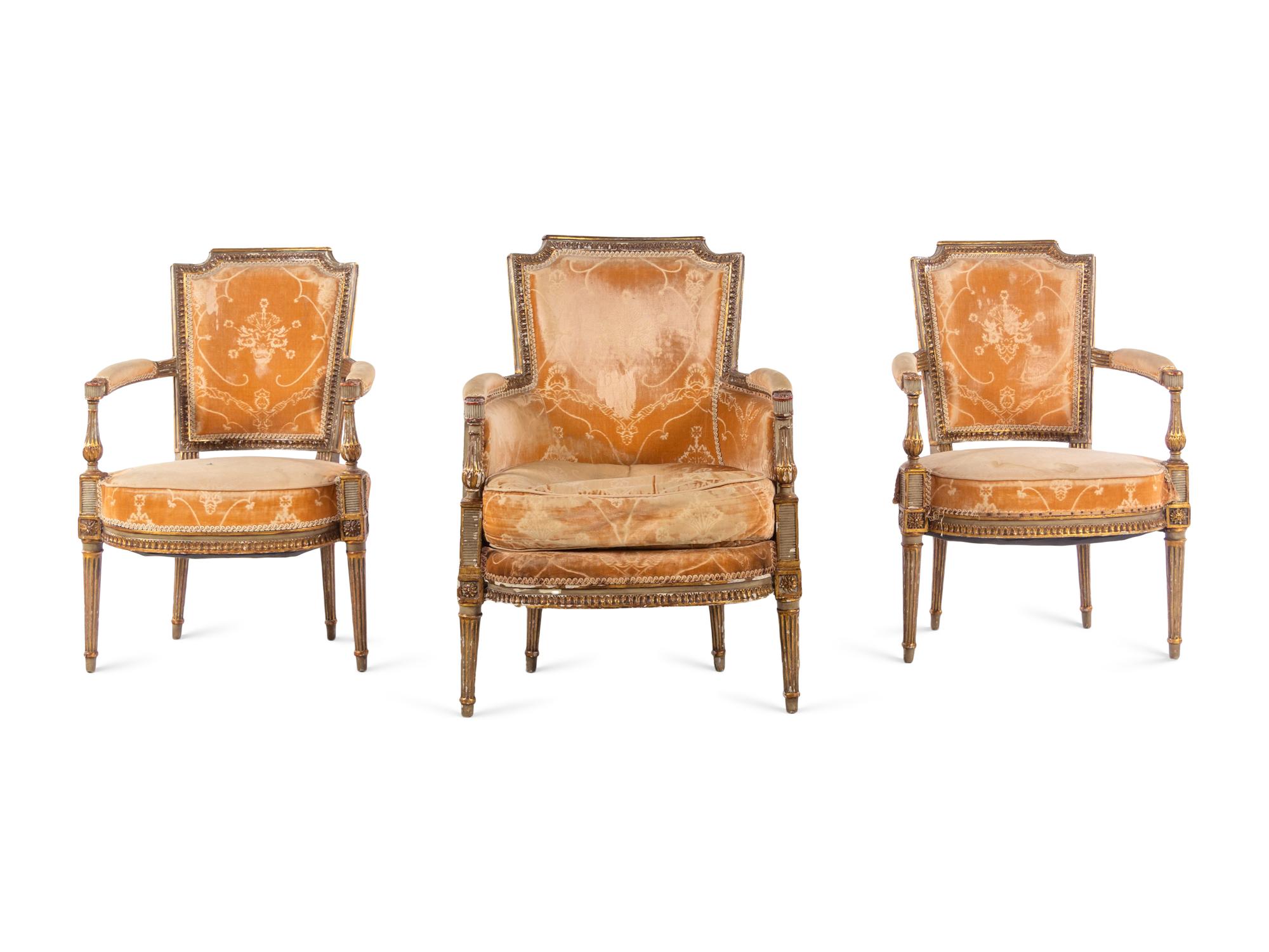 A Pair of Directoire Painted and Parcel Gilt Fauteuils and a Directoire Painted and Parcel Gilt Bergère