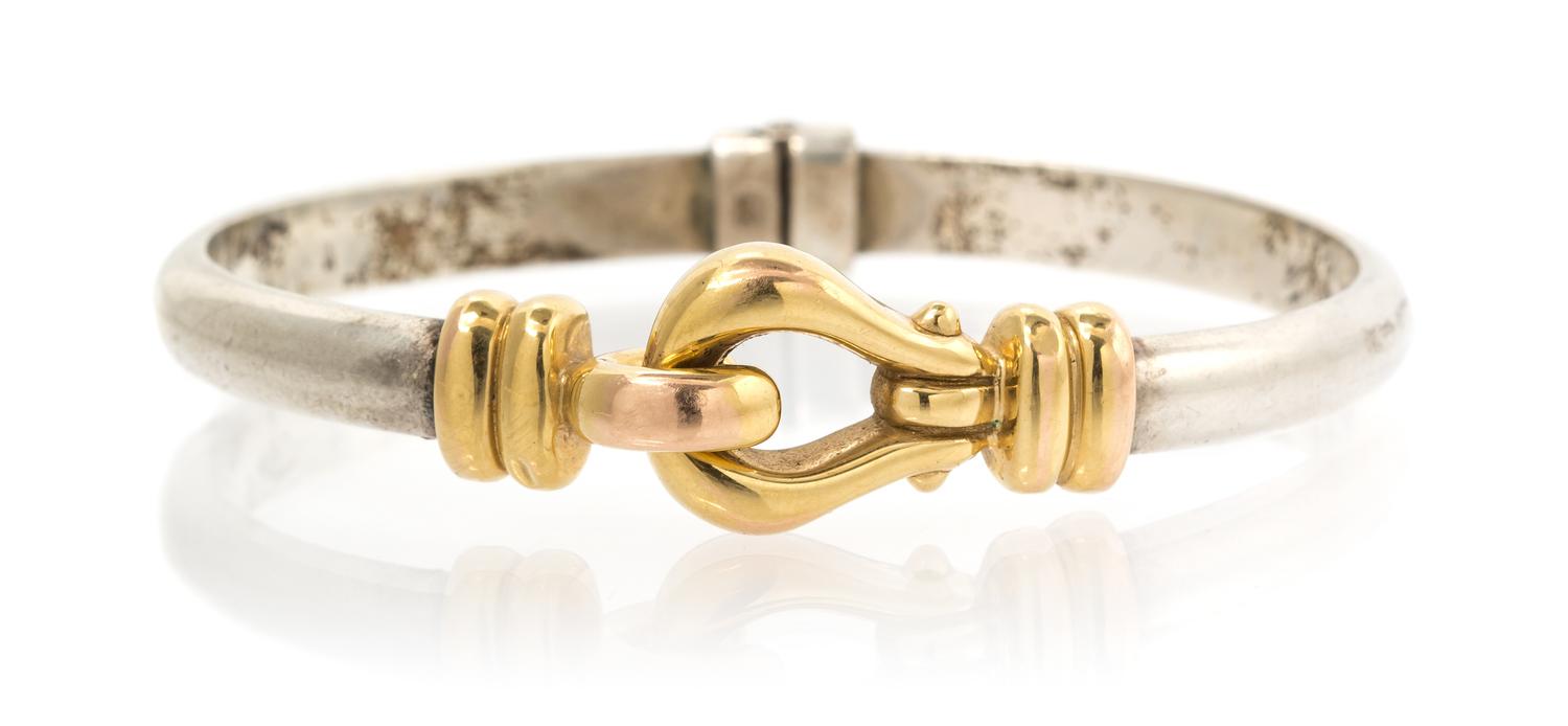 A 14 Karat Yellow Gold and Sterling Silver Bangle Bracelet, 19.90 dwts.