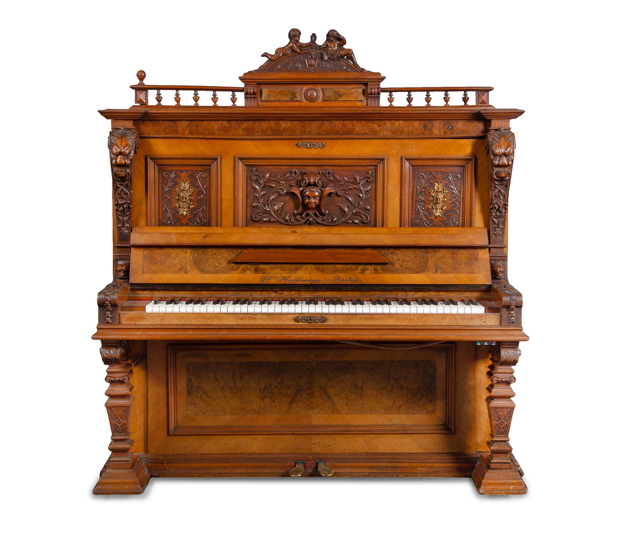 A German Carved Walnut Upright Player Piano and Upholstered Bench