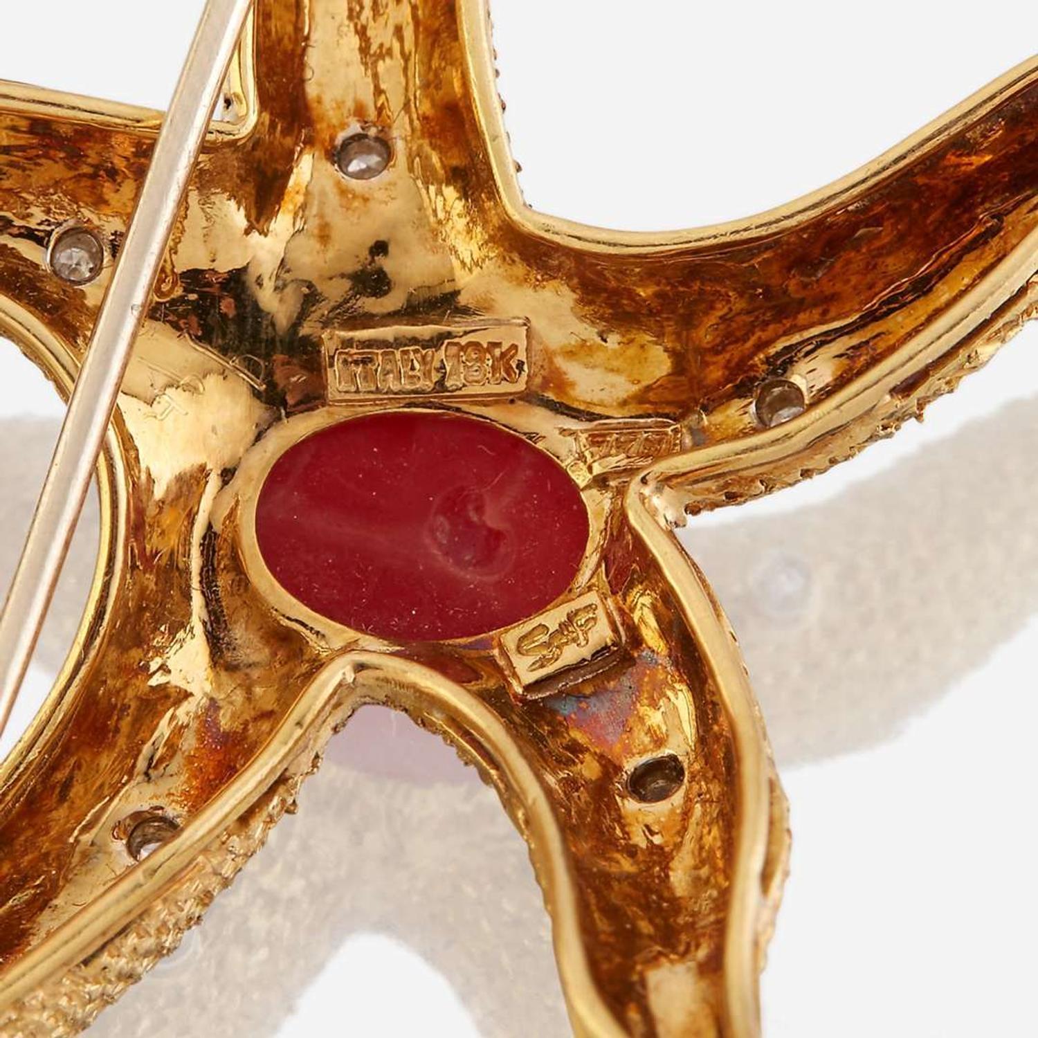 A group of two eighteen karat gold and gem-set brooches