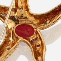A group of two eighteen karat gold and gem-set brooches