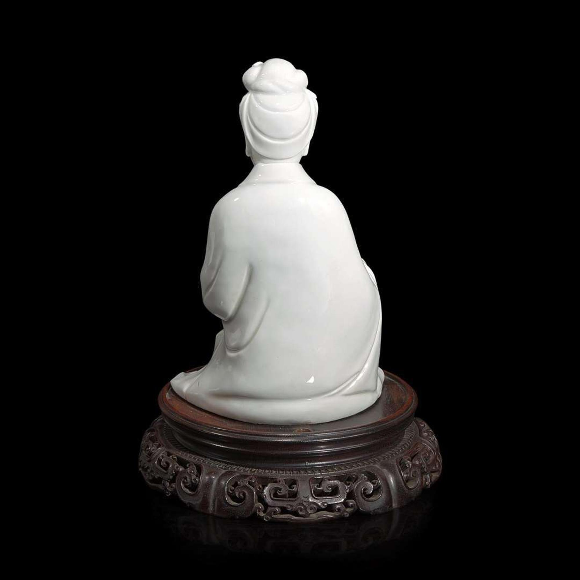 A Chinese blanc de Chine figure of Guanyin seated, with scroll 白瓷持卷轴观音像 Boji Yuren mark ?????