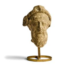 A Greek Terracotta Head of a Satyr