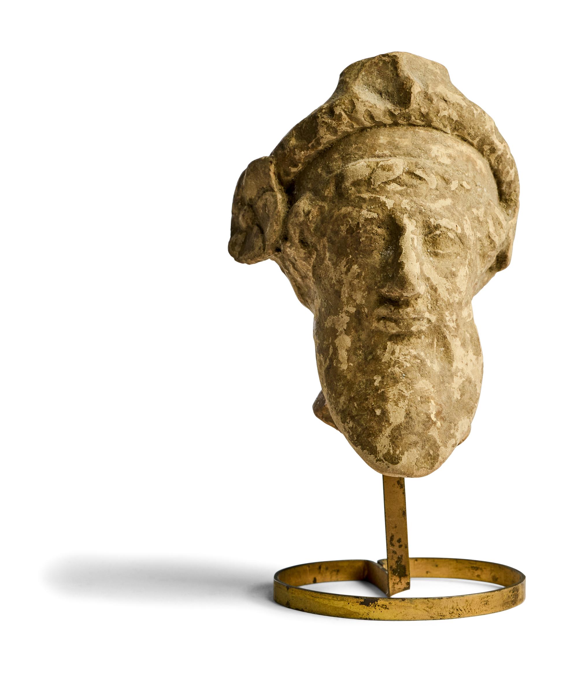 A Greek Terracotta Head of a Satyr