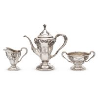 An Art Nouveau Three-Piece Sterling Silver Floral Cast and Repousse Coffee Service