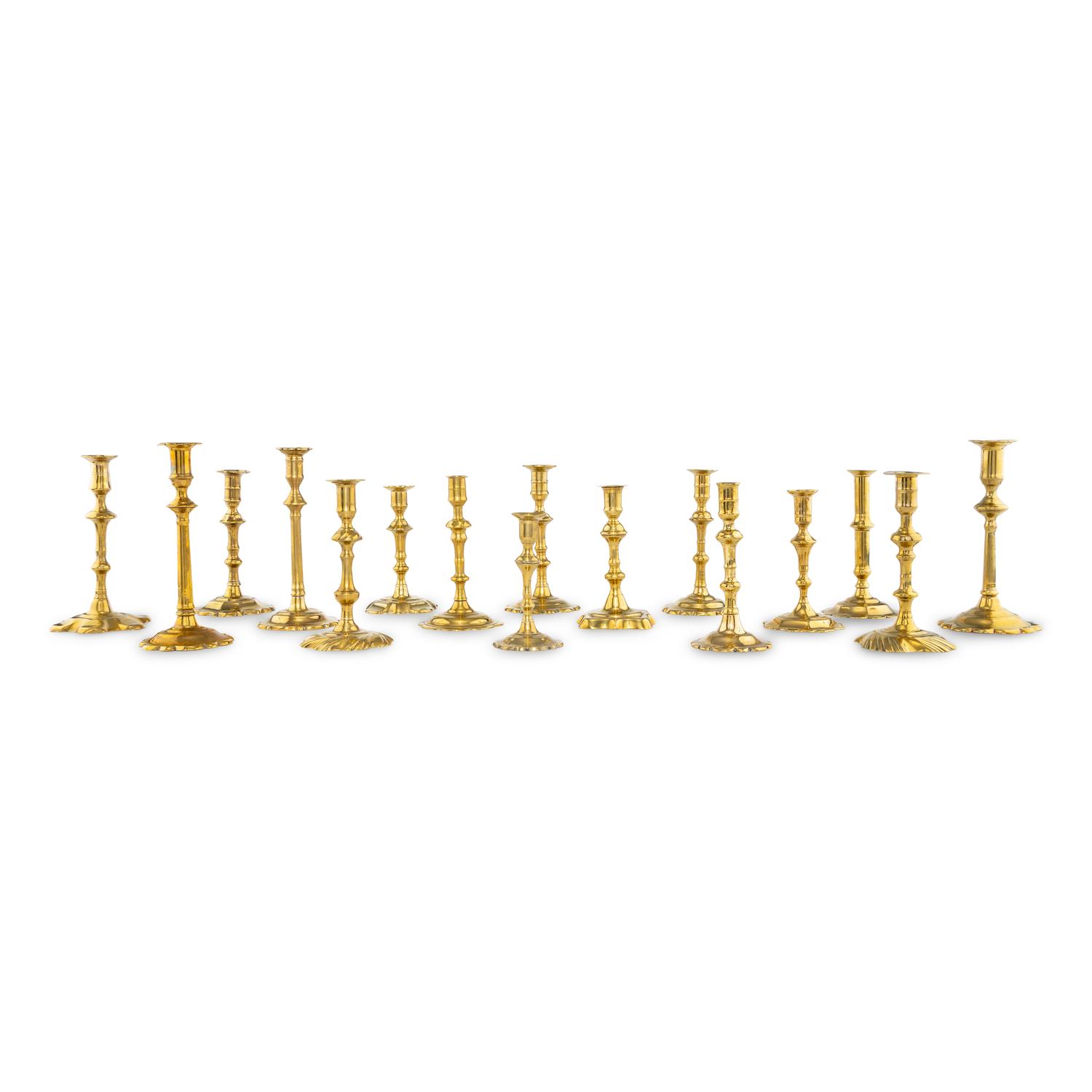 A Group of Sixteen Brass Candlesticks