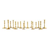 A Group of Sixteen Brass Candlesticks