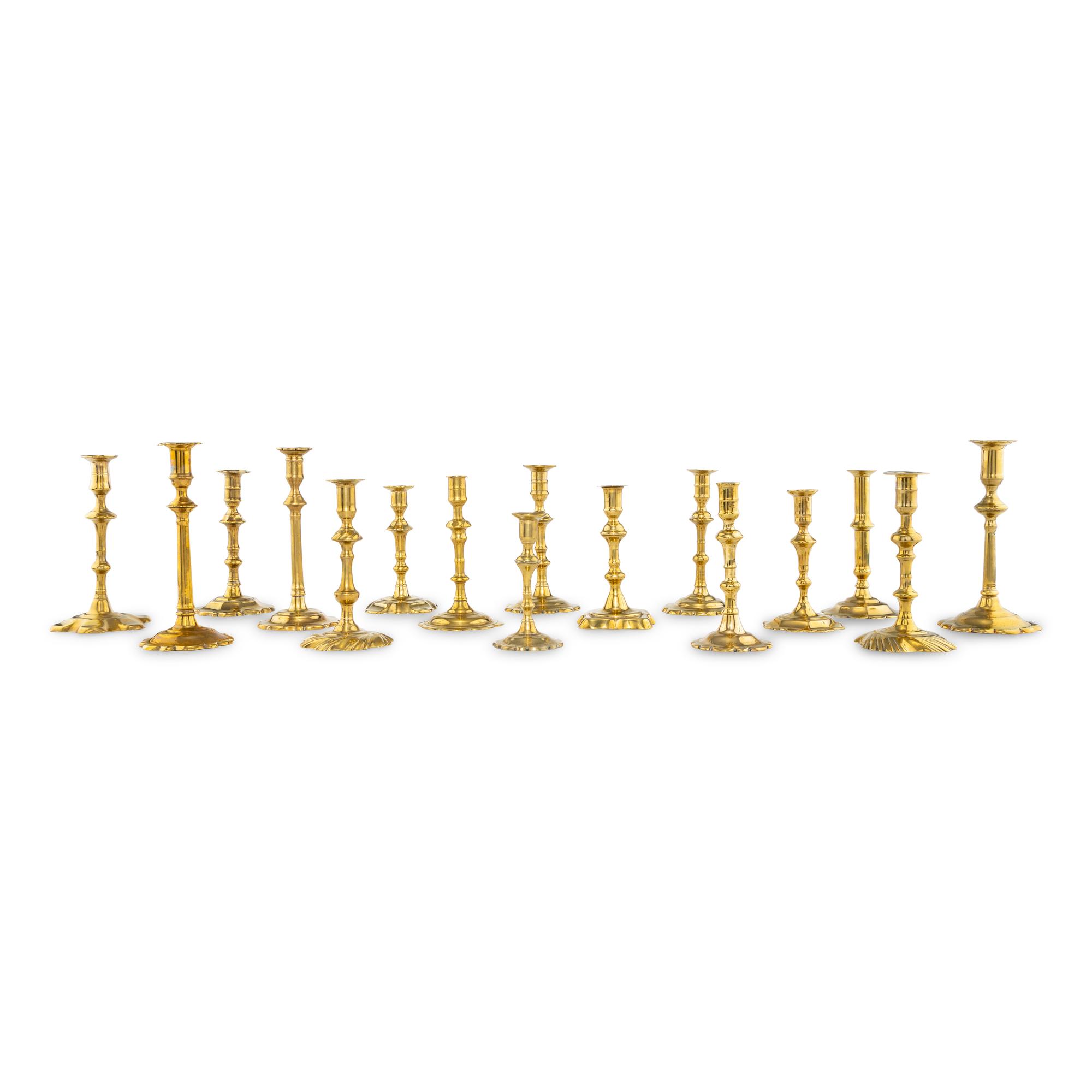 A Group of Sixteen Brass Candlesticks