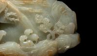 A Chinese Carved Russet and Pale Celadon Jade Boulder