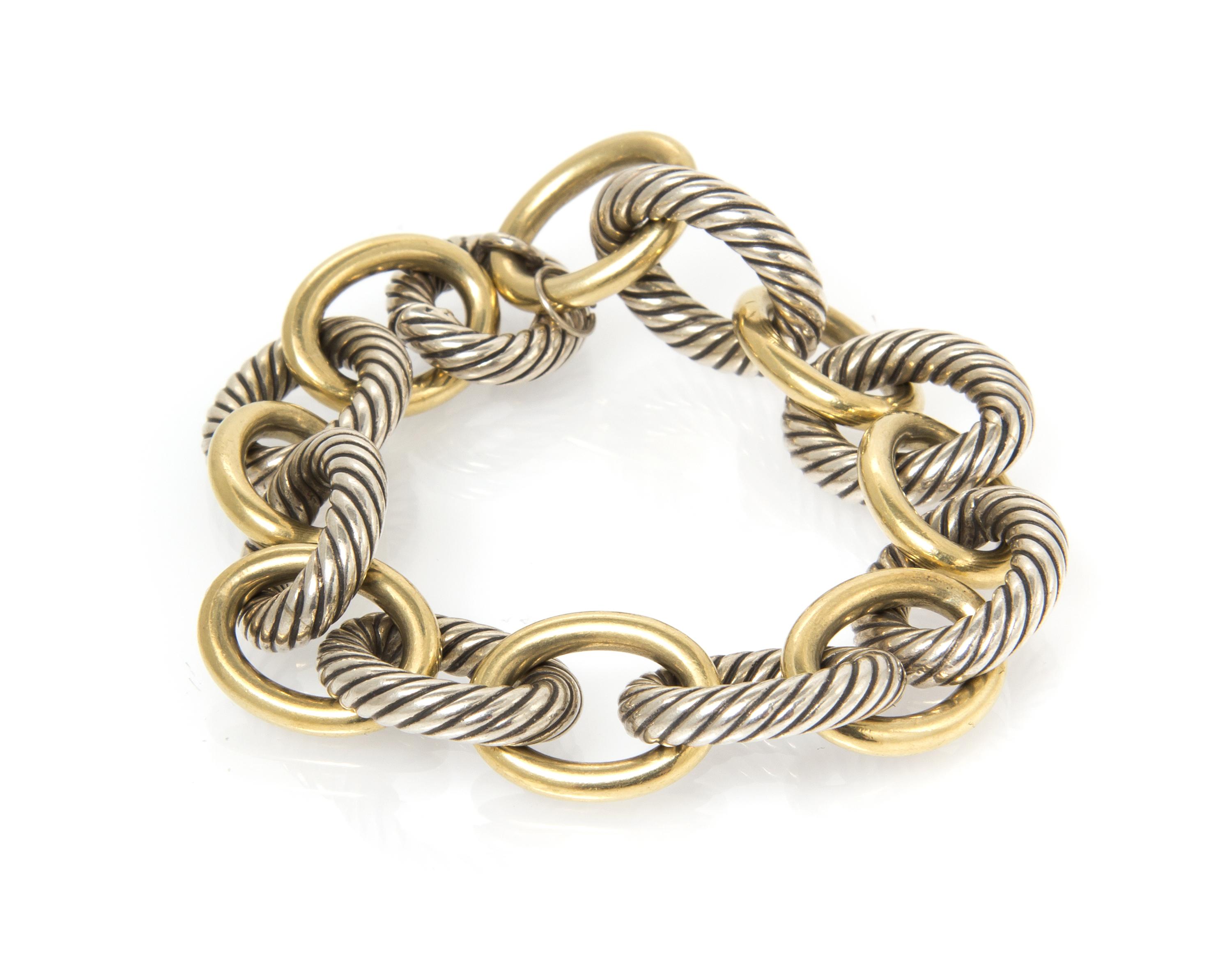 A Sterling and Yellow Gold Link Bracelet, 40.30 dwts.