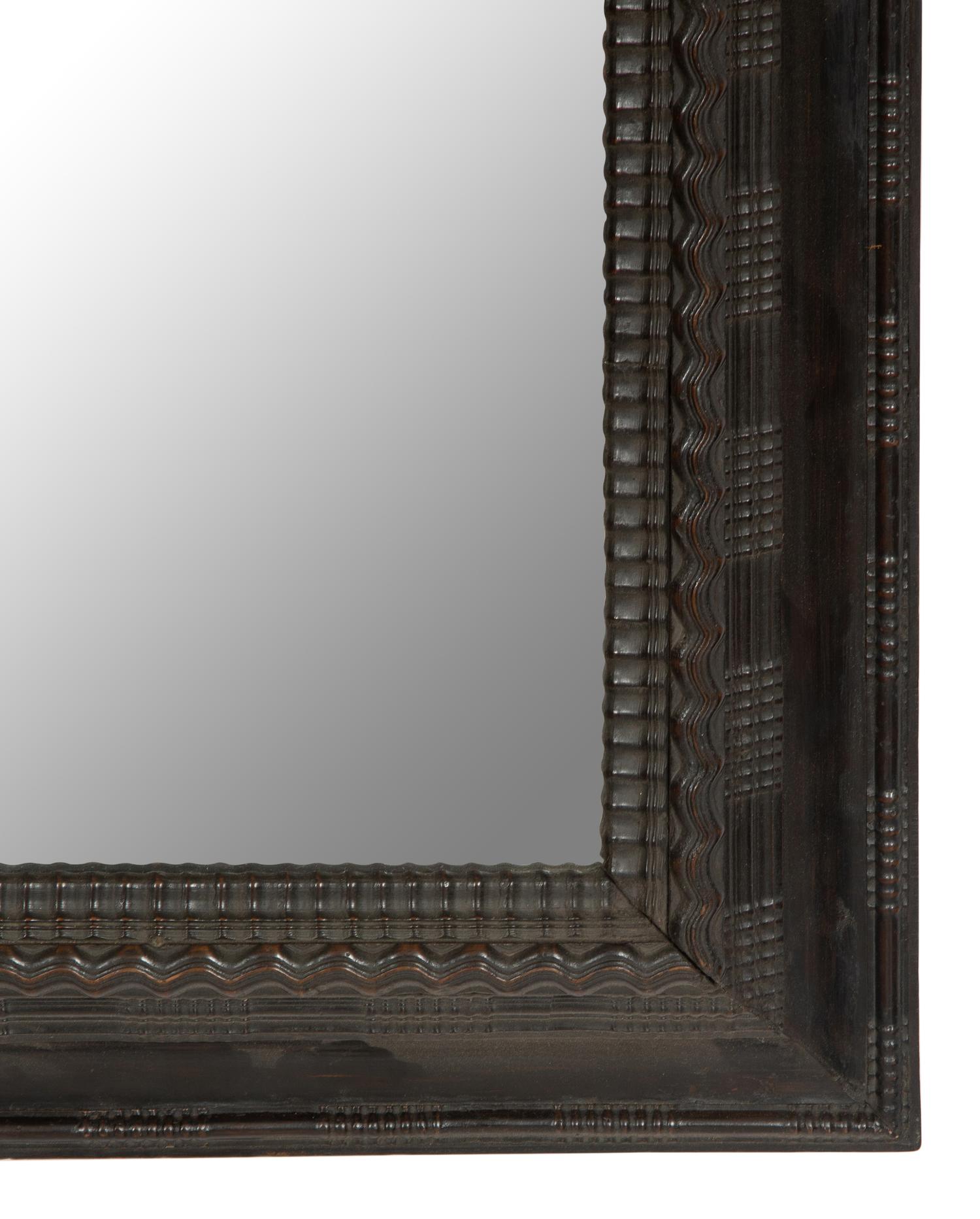 A Continental Ebonized Cushion Mirror