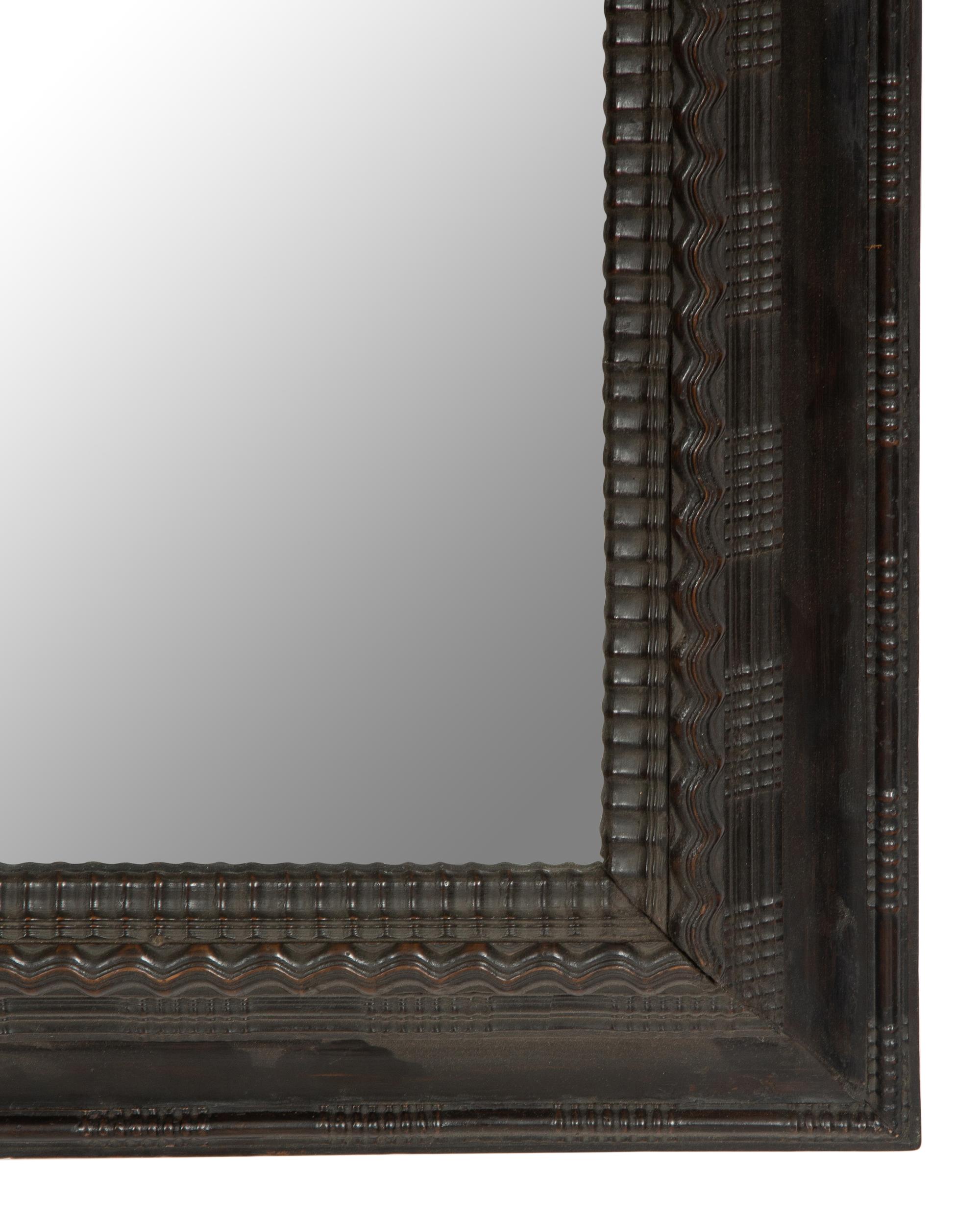A Continental Ebonized Cushion Mirror