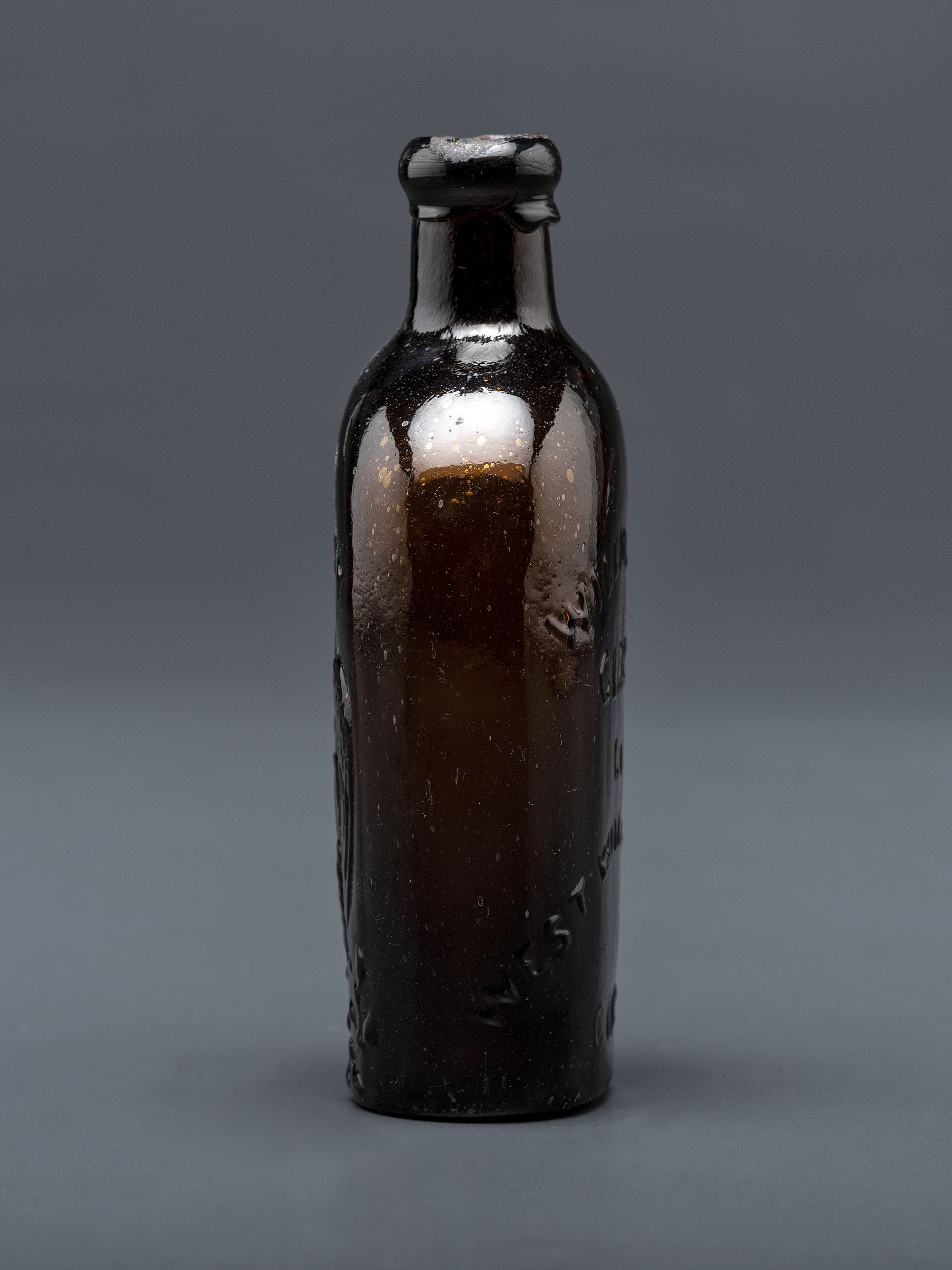 A Molded-Glass Flask in Amber by Willington Glass Company, Connecticut