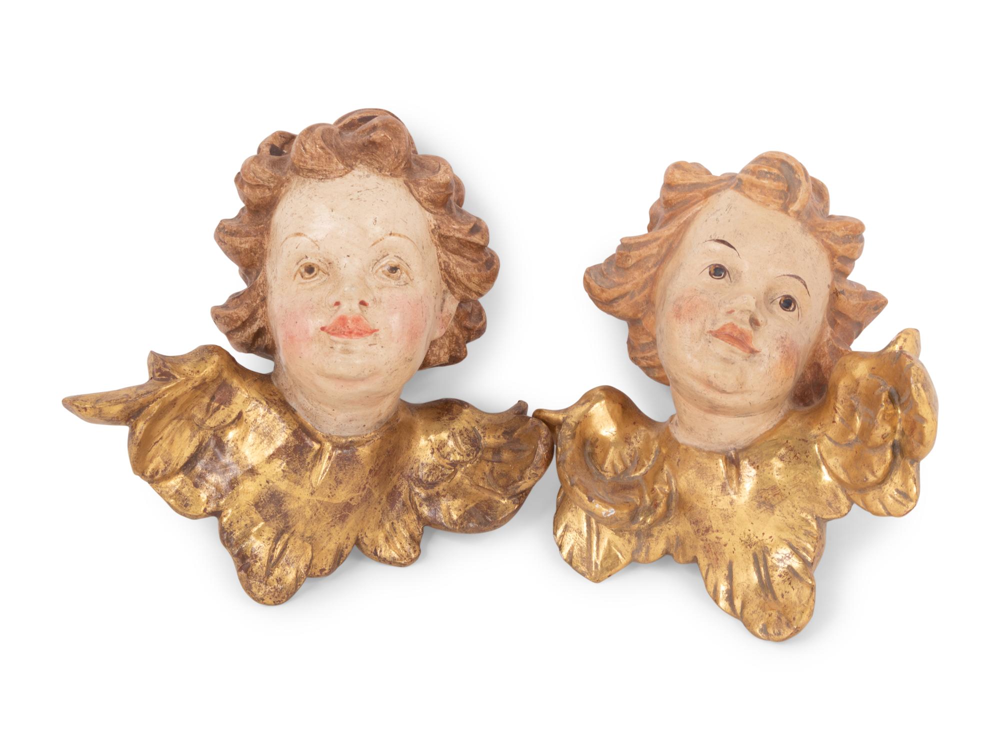 A Pair of Continental Painted and Parcel Gilt Putto Masks