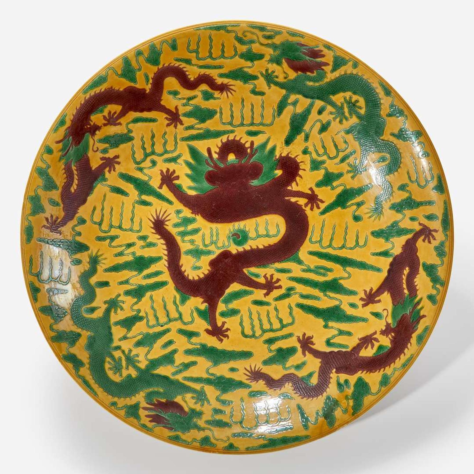 A large Chinese yellow-ground “Dragons” charger