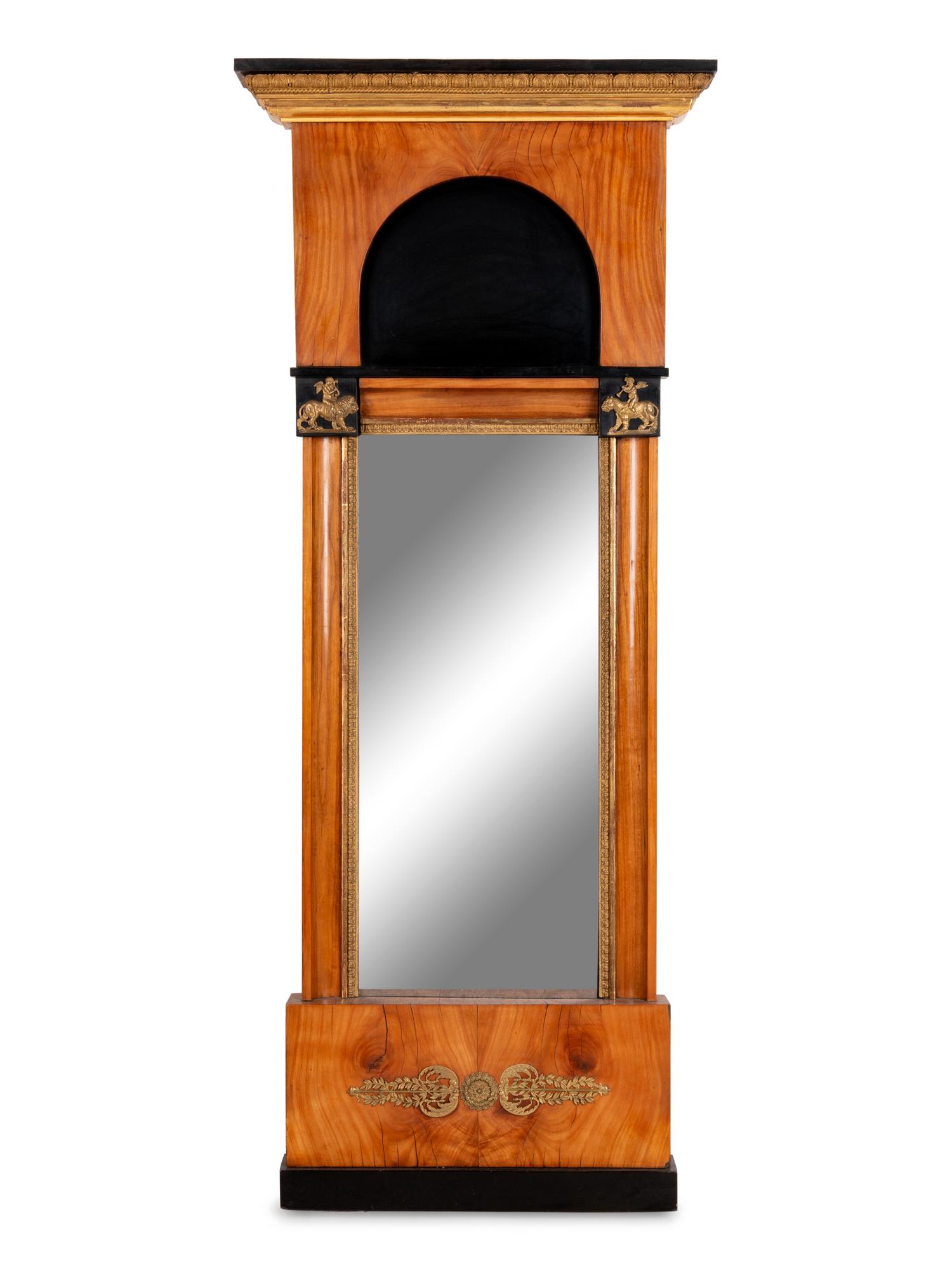 A Biedermeier Parcel Ebonized and Gilt Metal Mounted Mirror