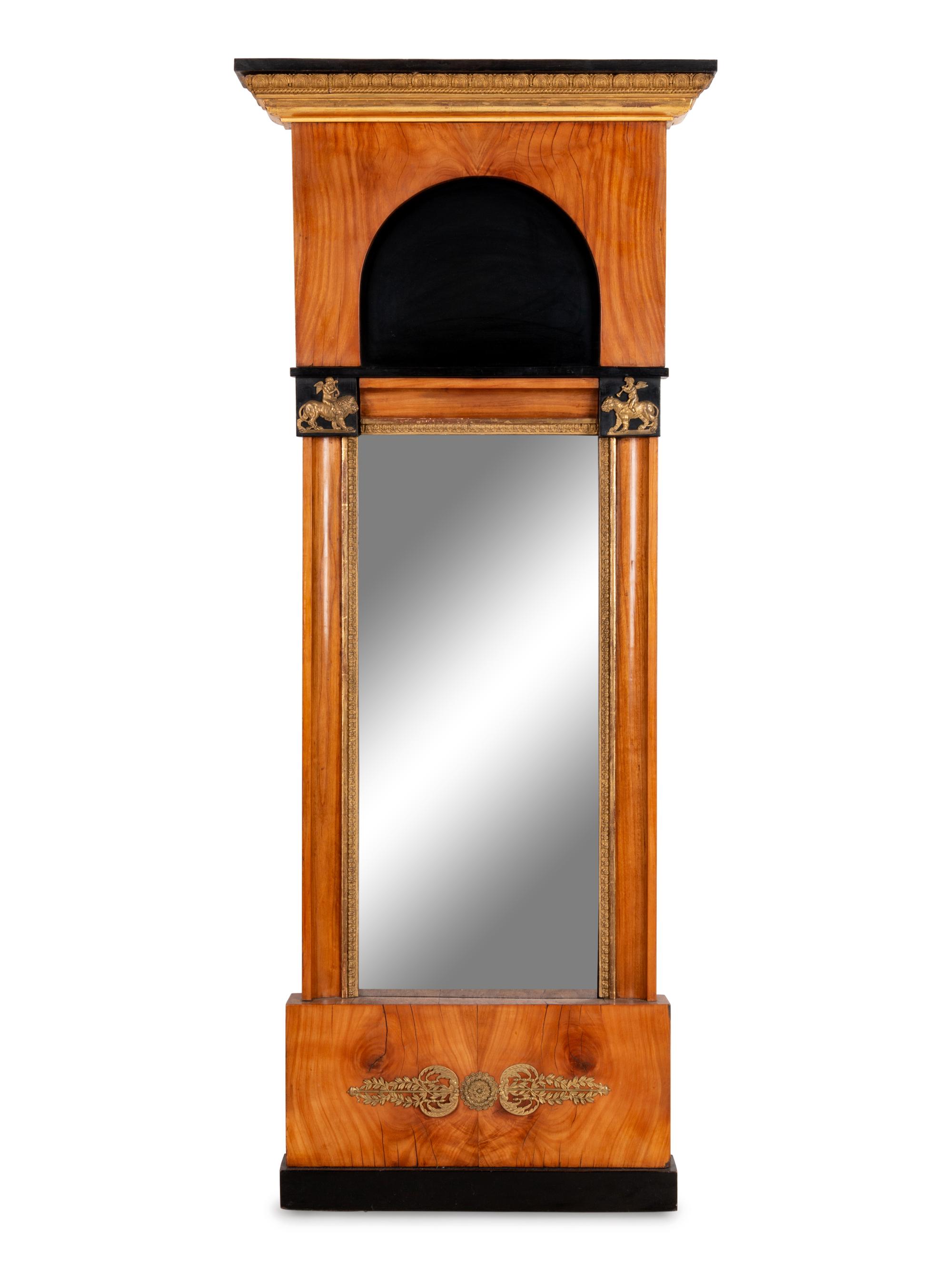 A Biedermeier Parcel Ebonized and Gilt Metal Mounted Mirror