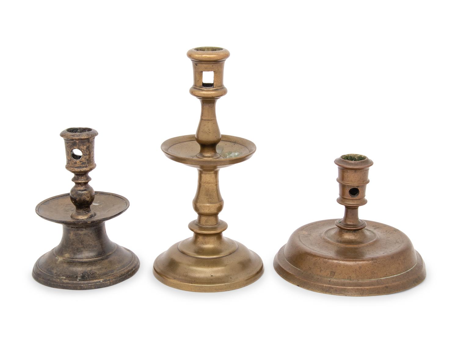 A Group of Three Dutch Brass Candlesticks