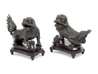 A Pair of Chinese Bronze Buddhistic Lions with Wood Stands
