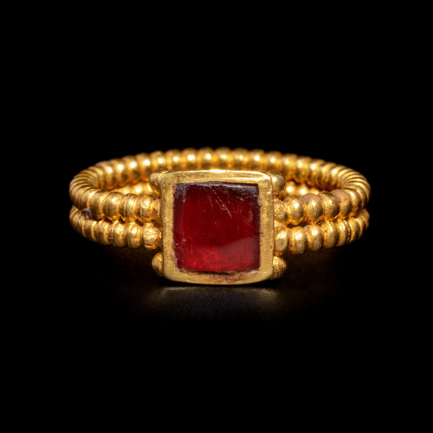 A Roman Gold and Garnet Finger Ring with Cabochon