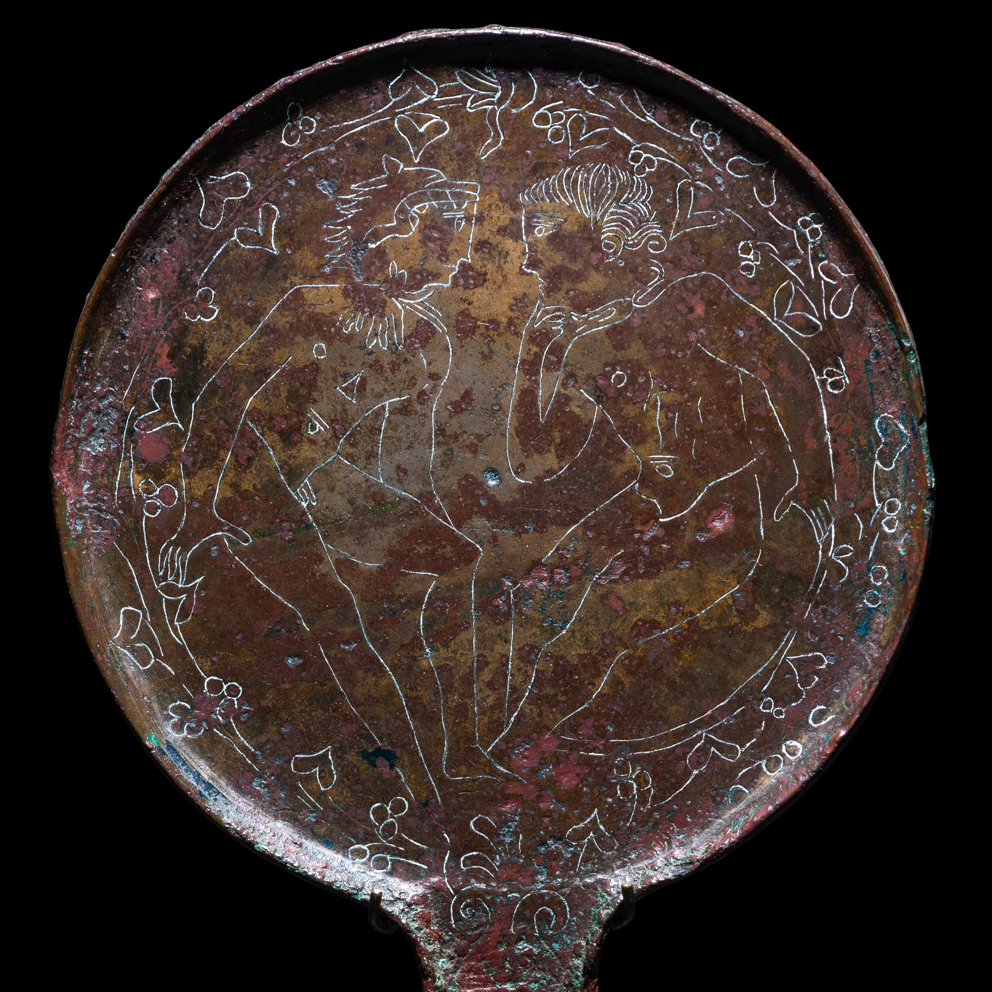 An Etruscan Bronze Mirror with Incised Scene of Hercules and Apollo