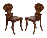 A Pair of French Empire Style Gilt Metal Mounted Mahogany Hall Chairs