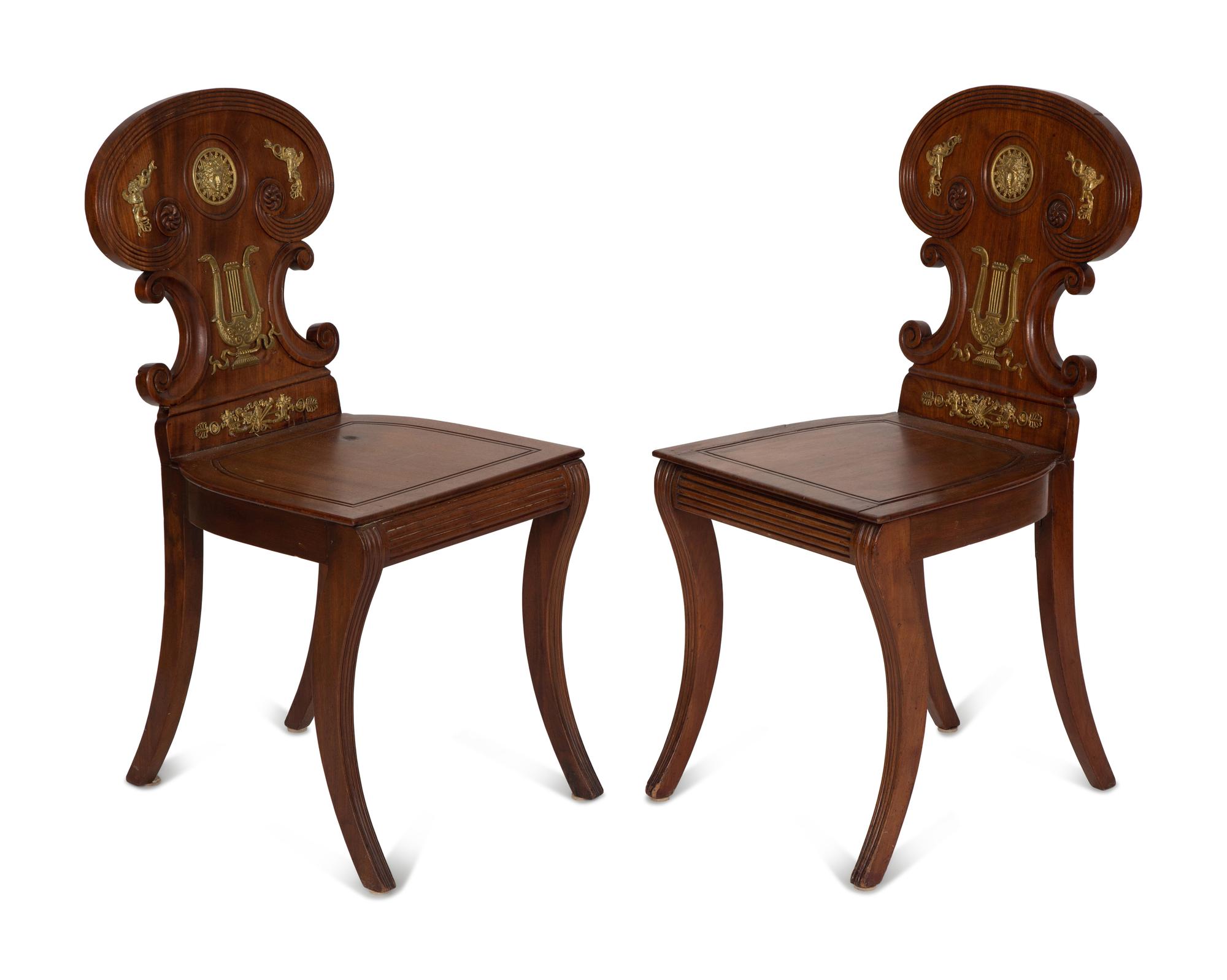 A Pair of French Empire Style Gilt Metal Mounted Mahogany Hall Chairs