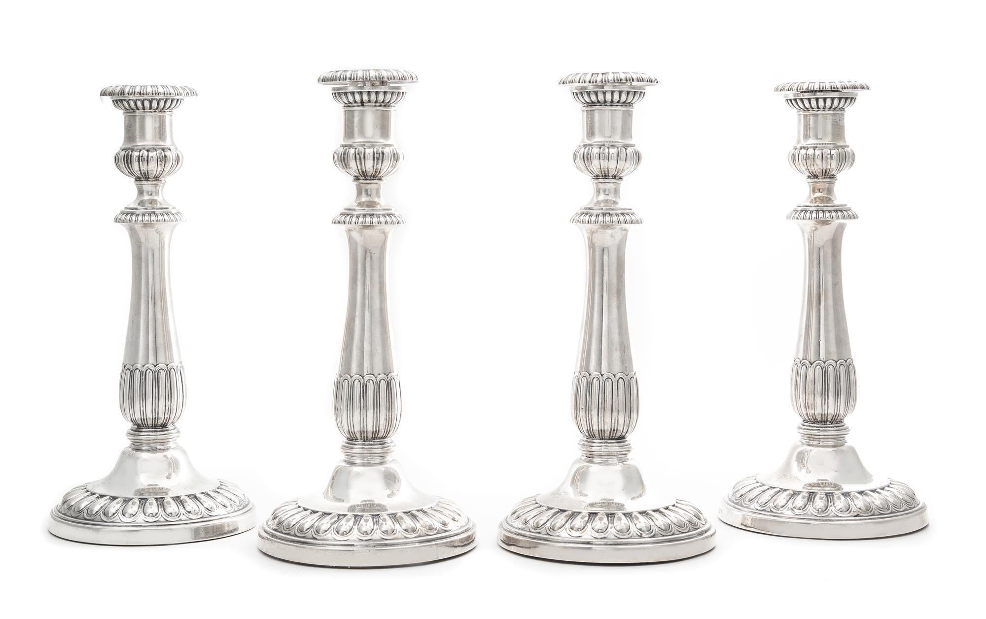 A Set of Four George III Silver Candlesticks, John Roberts & Co., Sheffield, 1808-9, each having an urn form candle cup with a gadroon
