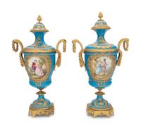 A Pair of Sèvres Style Gilt Bronze Mounted Porcelain Urns