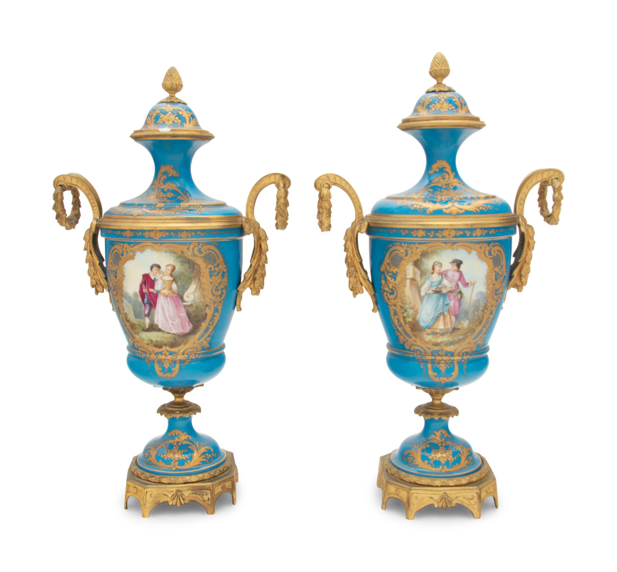 A Pair of Sèvres Style Gilt Bronze Mounted Porcelain Urns