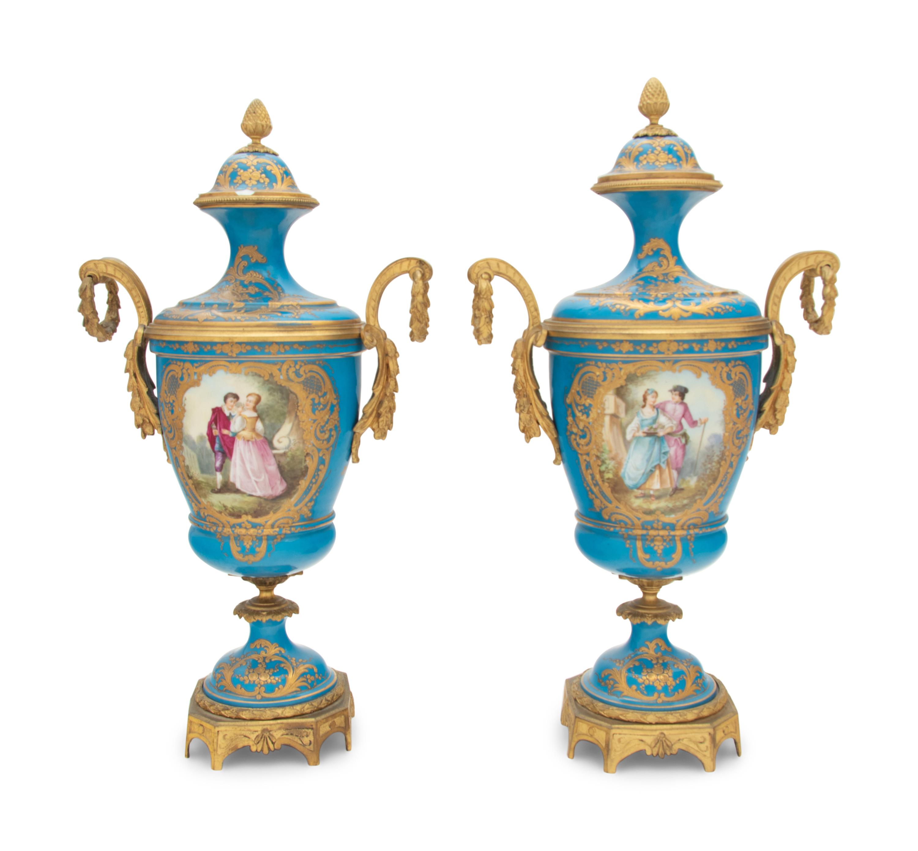A Pair of Sèvres Style Gilt Bronze Mounted Porcelain Urns
