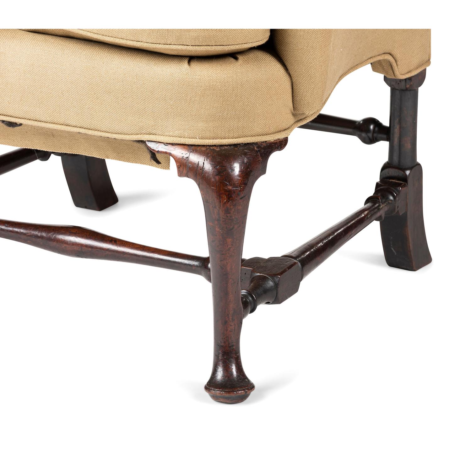 A Queen Anne Turned and Carved Walnut Stretcher Base and Pad Foot Easy Chair