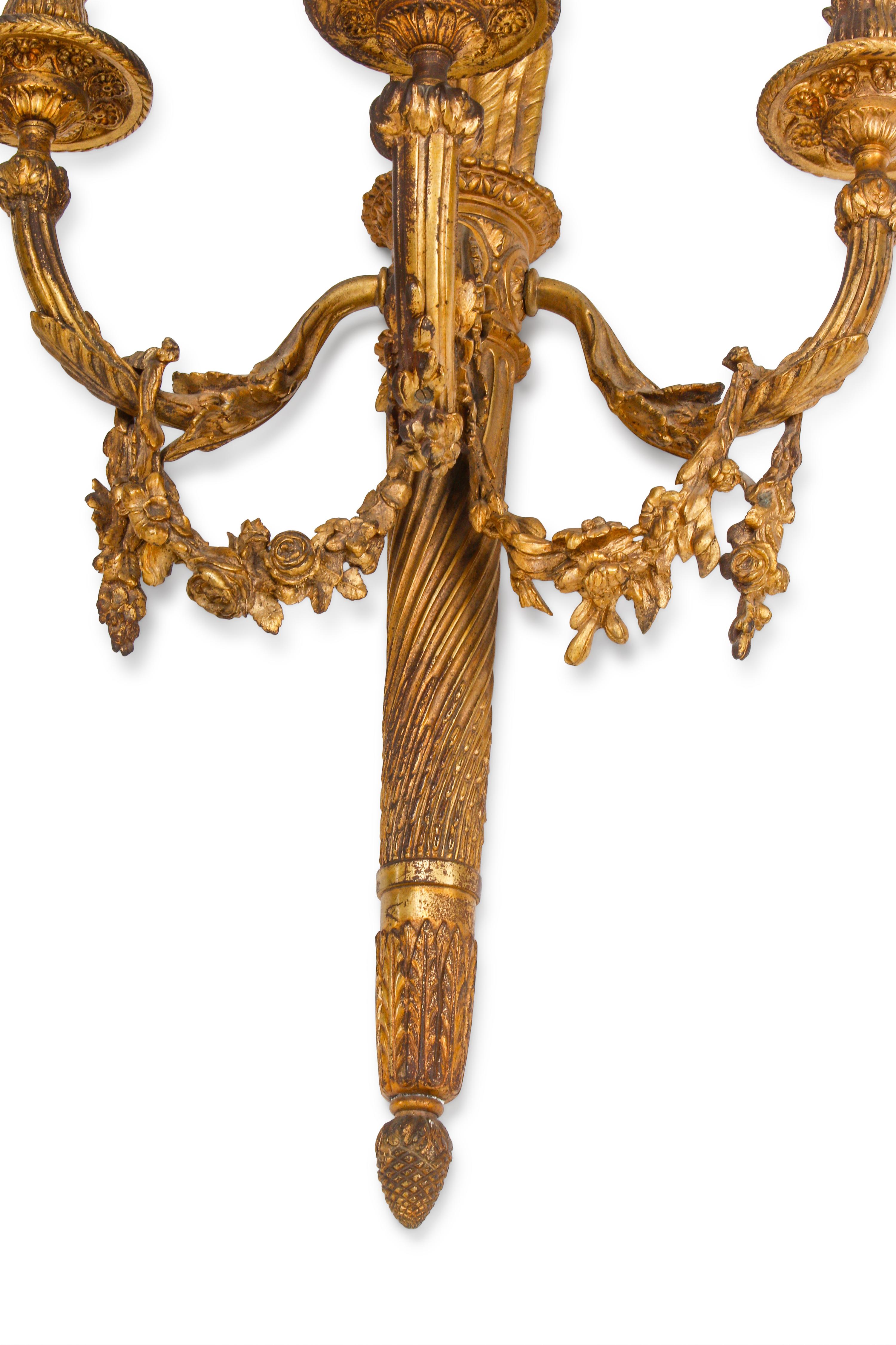 A Set of Four Louis XVI Style Gilt Bonze Three-Light Sconces