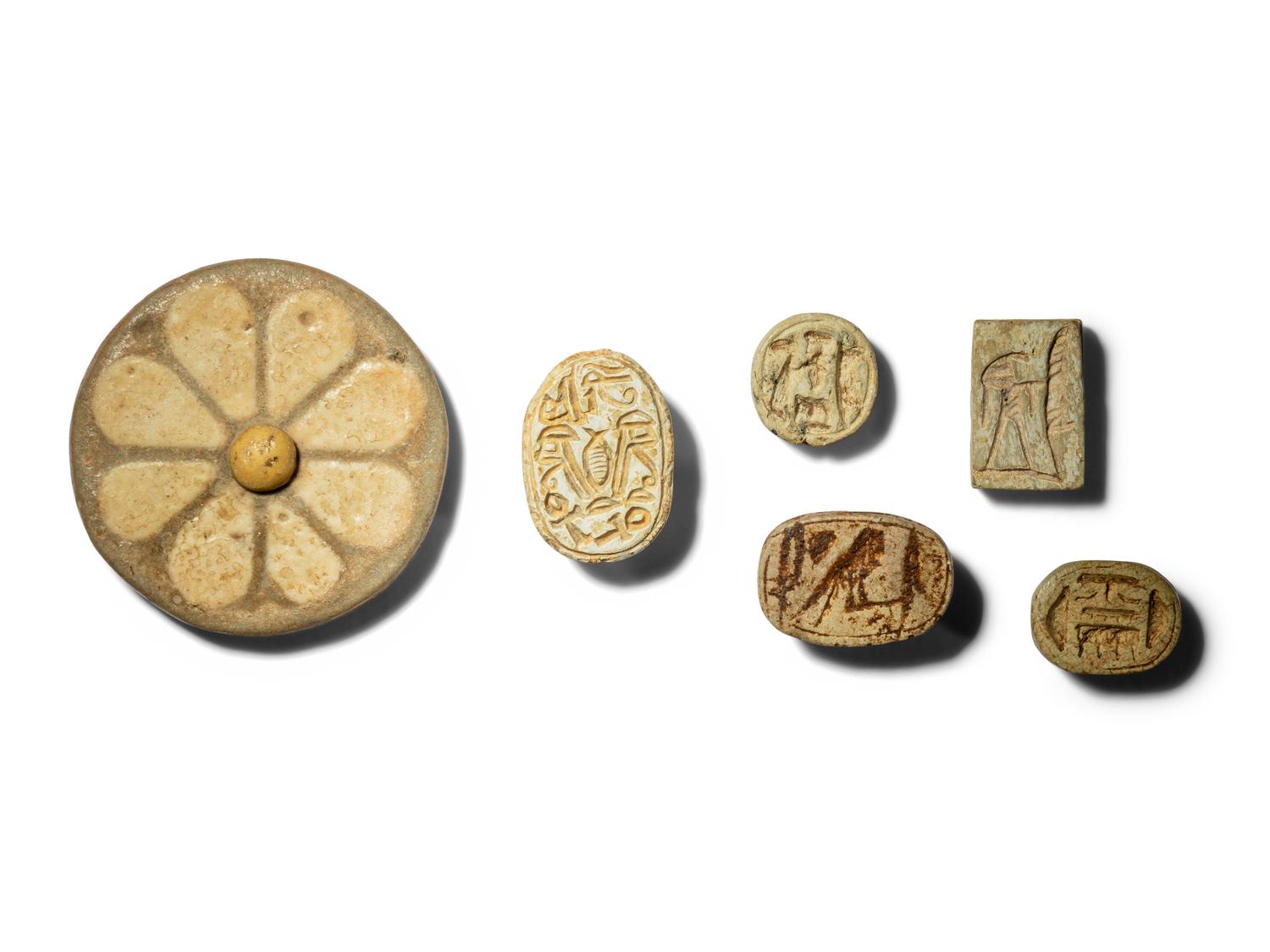 Five Egyptian Faience Seals and an Egyptian Faience Flower Rosette Inlay