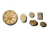 Five Egyptian Faience Seals and an Egyptian Faience Flower Rosette Inlay