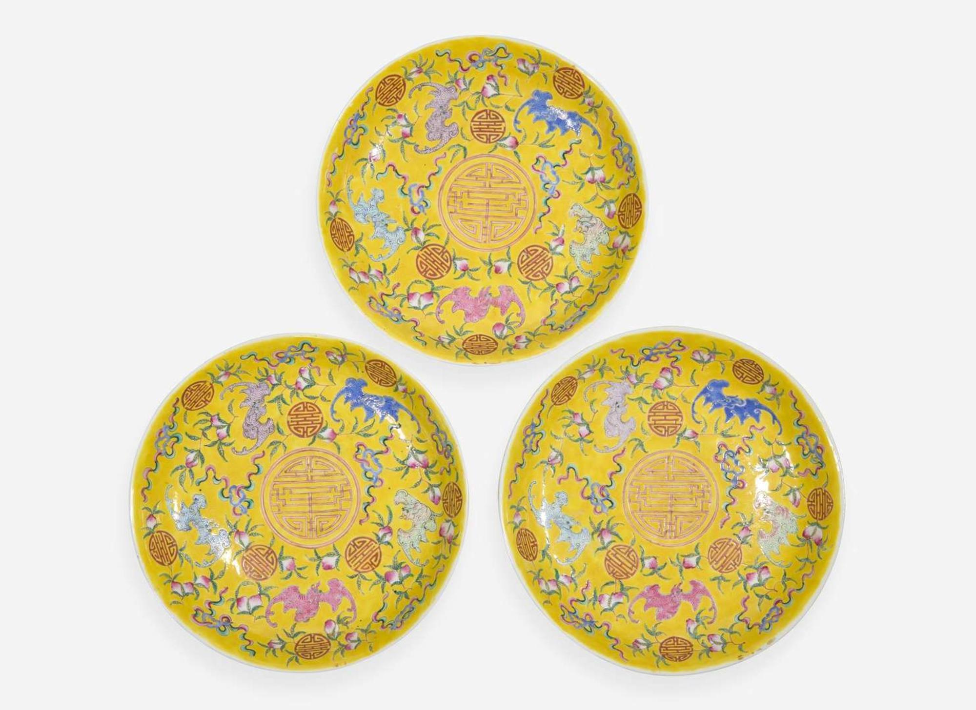 A group of three Chinese yellow-ground dishes, Guangxu marks and probably of the period 五蝙黃地盤一組三件 光緒款 或清光緒