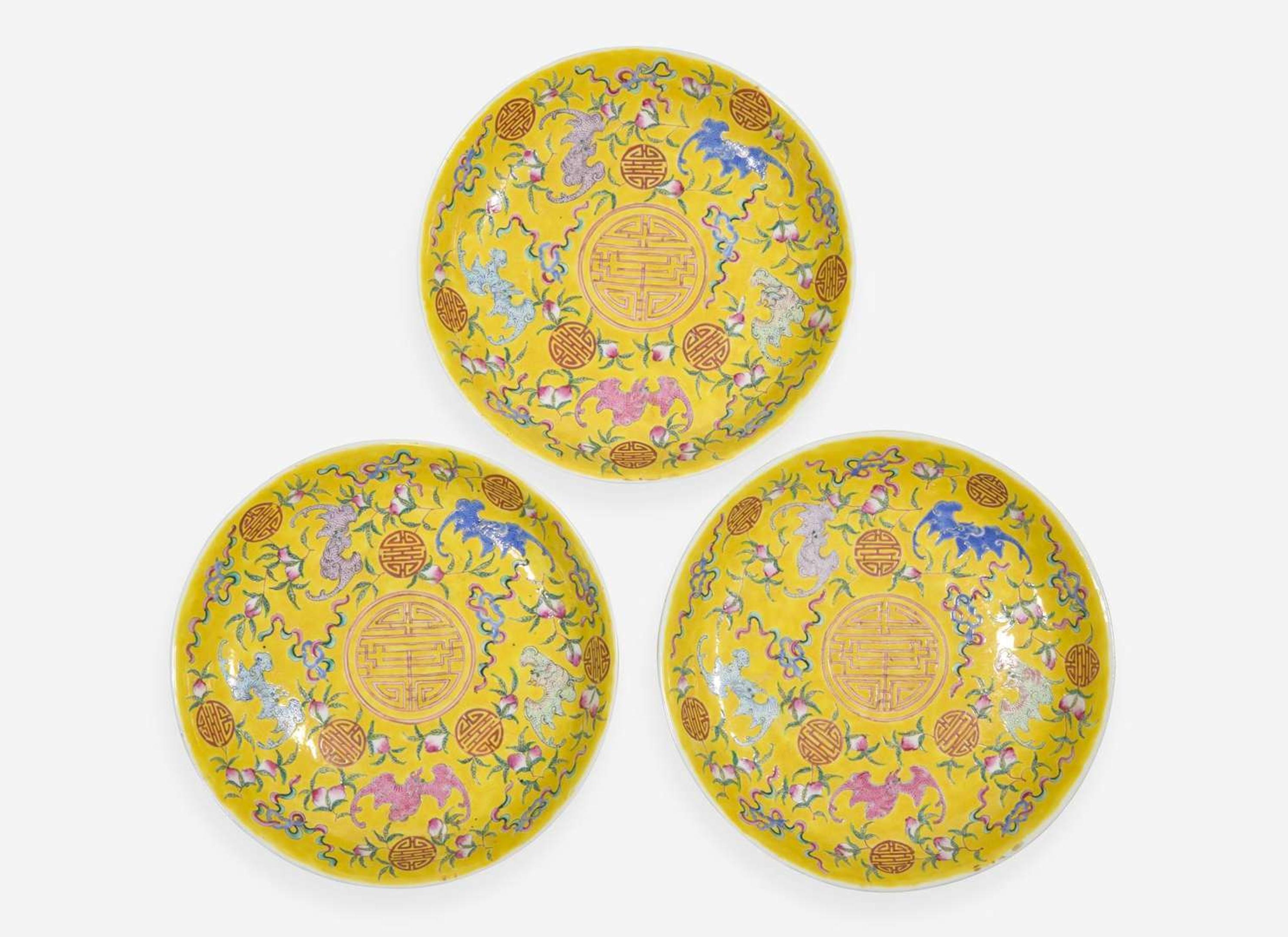 A group of three Chinese yellow-ground dishes, Guangxu marks and probably of the period 五蝙黃地盤一組三件 光緒款 或清光緒