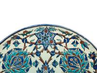 An Islamic Iznik Glazed Pottery Plate and a Small Vase