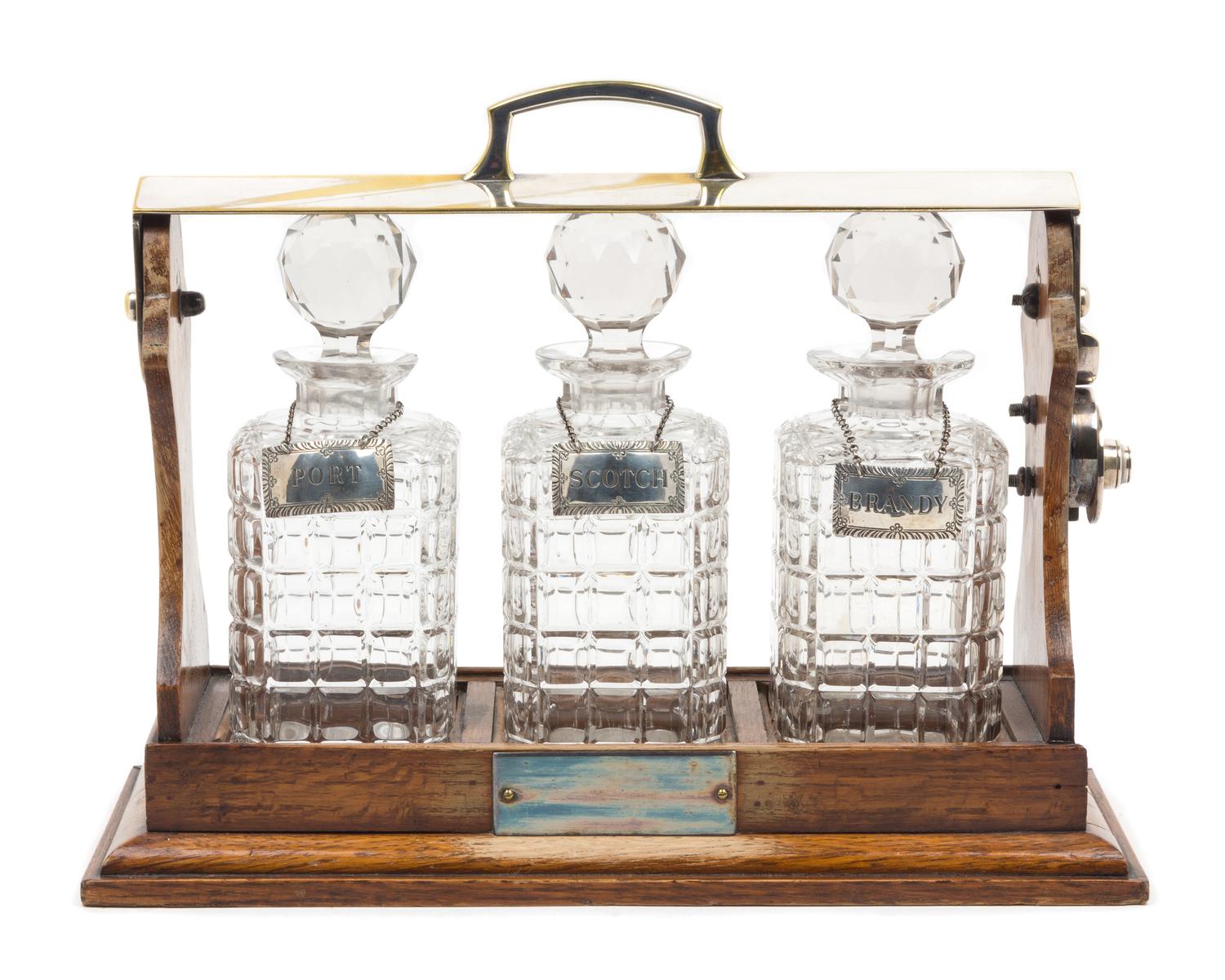 A Victorian Silver-Plate Mounted Oak Tantalus Height 9 3/4 x width 15 1/8 inches. — 19TH CENTURY