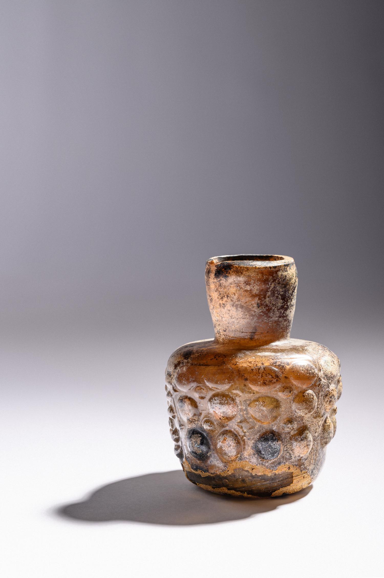 An Islamic Dark Yellow Glass Flask