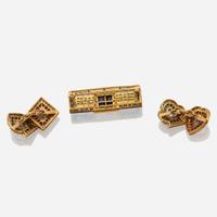 A gold, sapphire, and diamond brooch with similar cufflinks