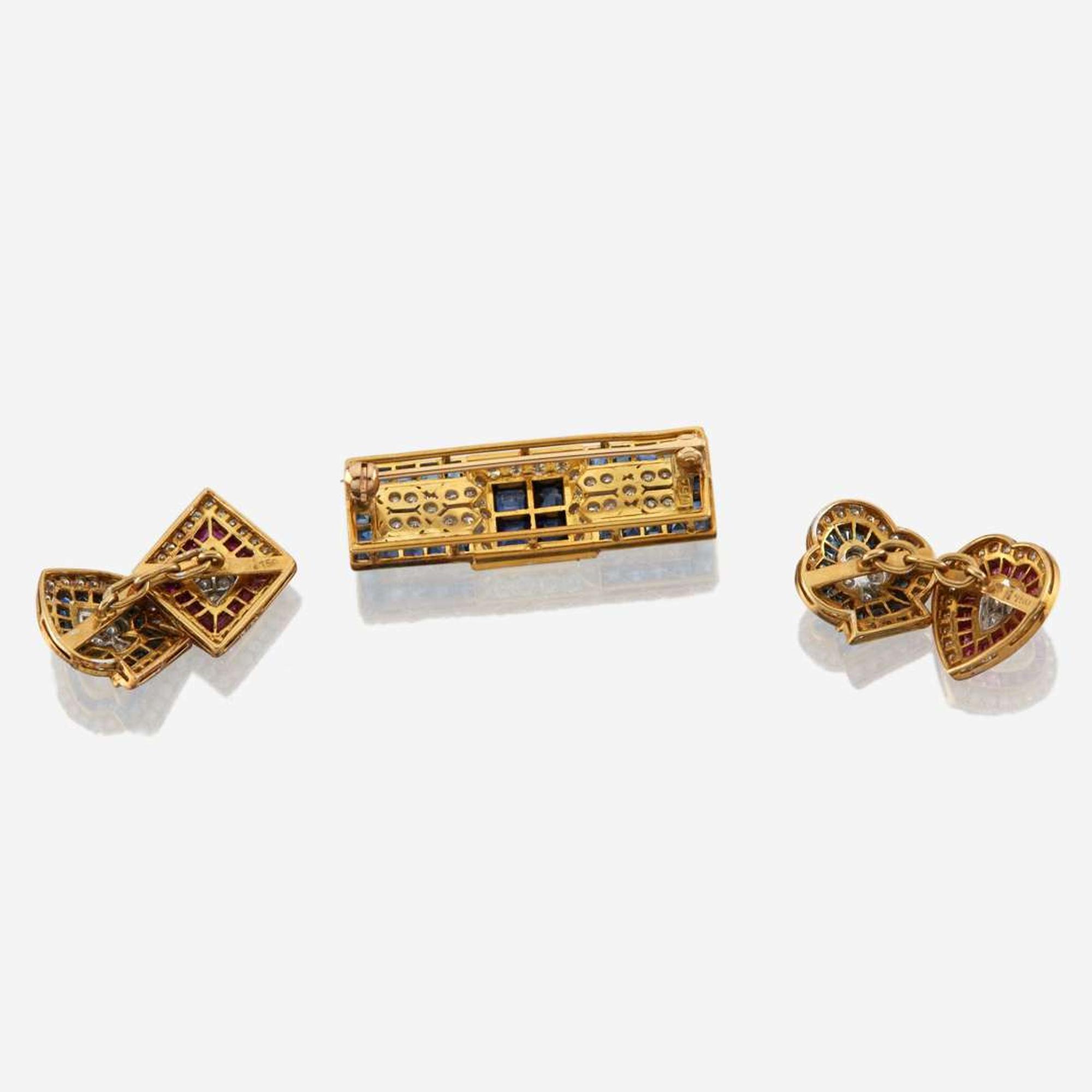 A gold, sapphire, and diamond brooch with similar cufflinks