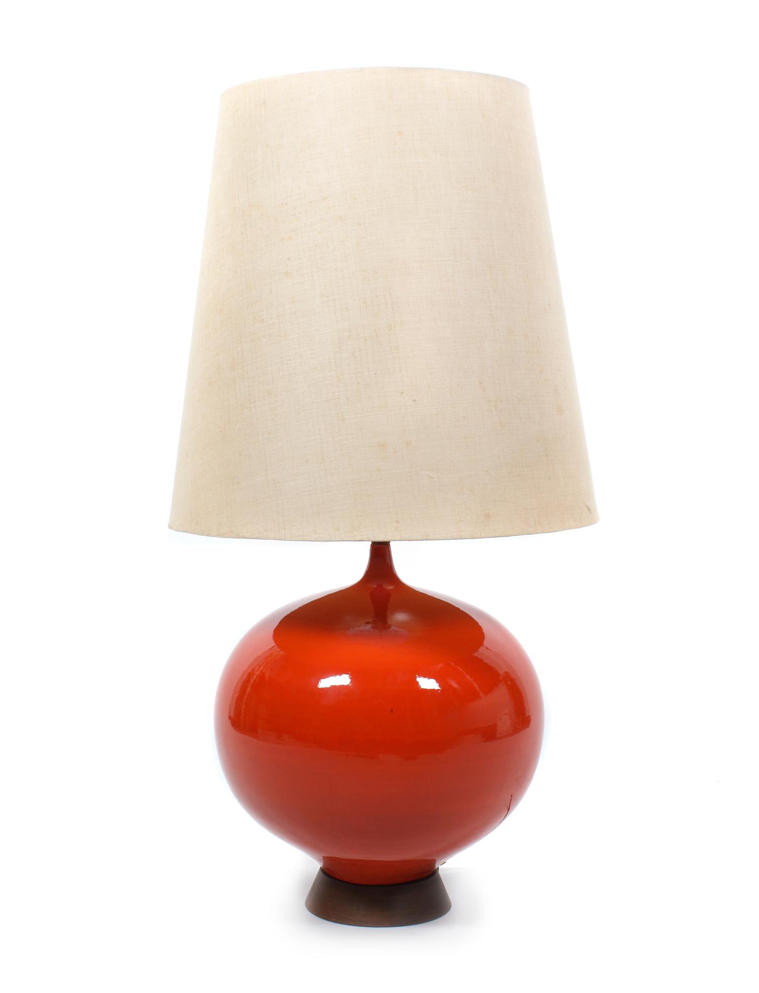 A Red Ceramic and Wood Table Lamp Height 41 inches. — MID 20TH CENTURY