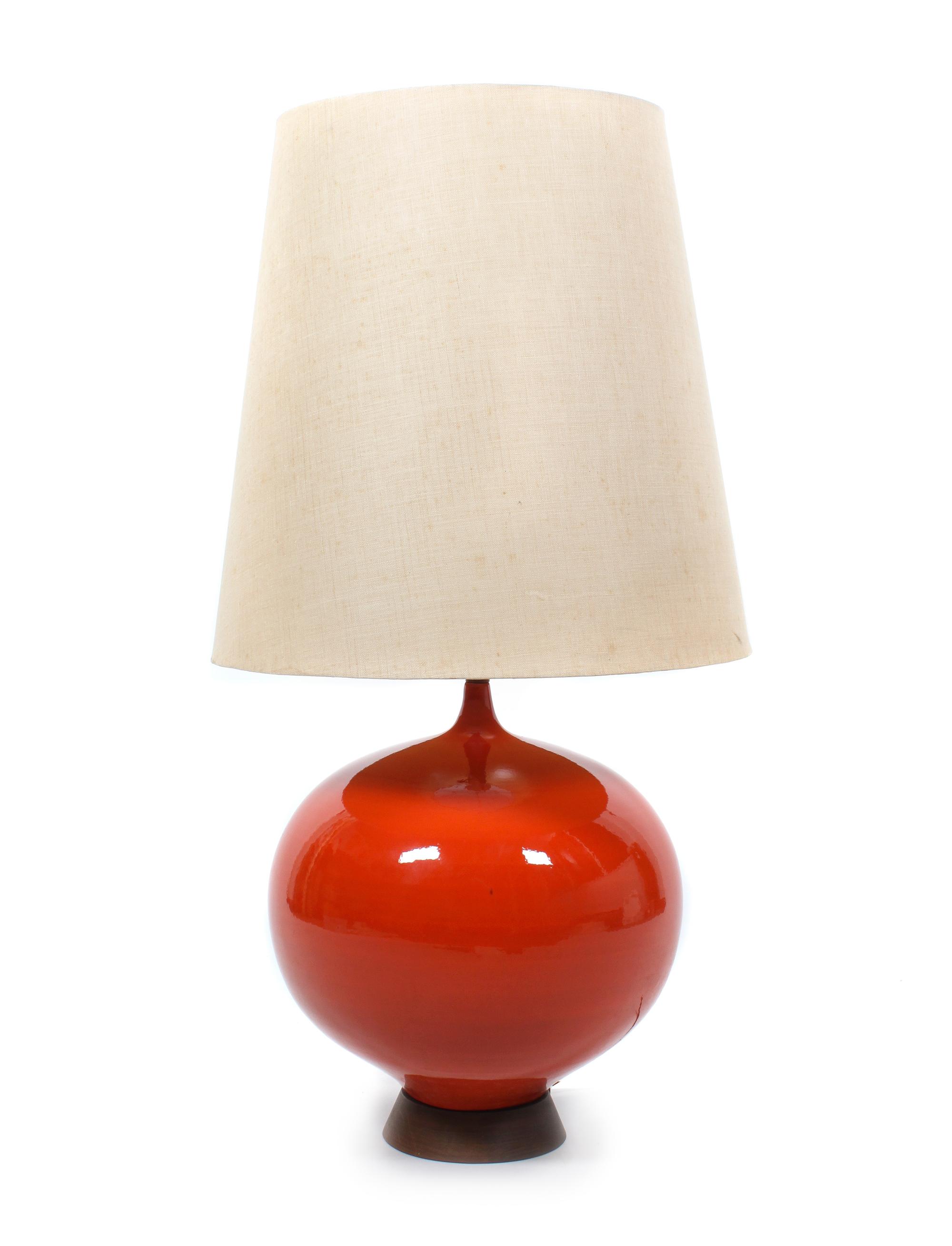 A Red Ceramic and Wood Table Lamp Height 41 inches. — MID 20TH CENTURY