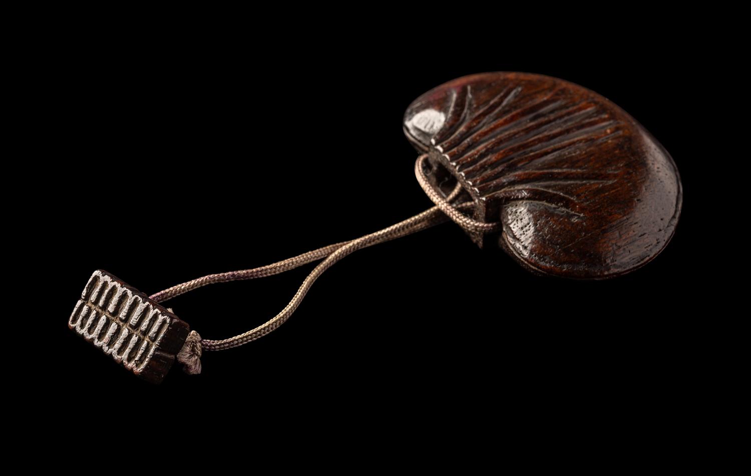 A Chinese Carved Hardwood Purse-Form Perfumier