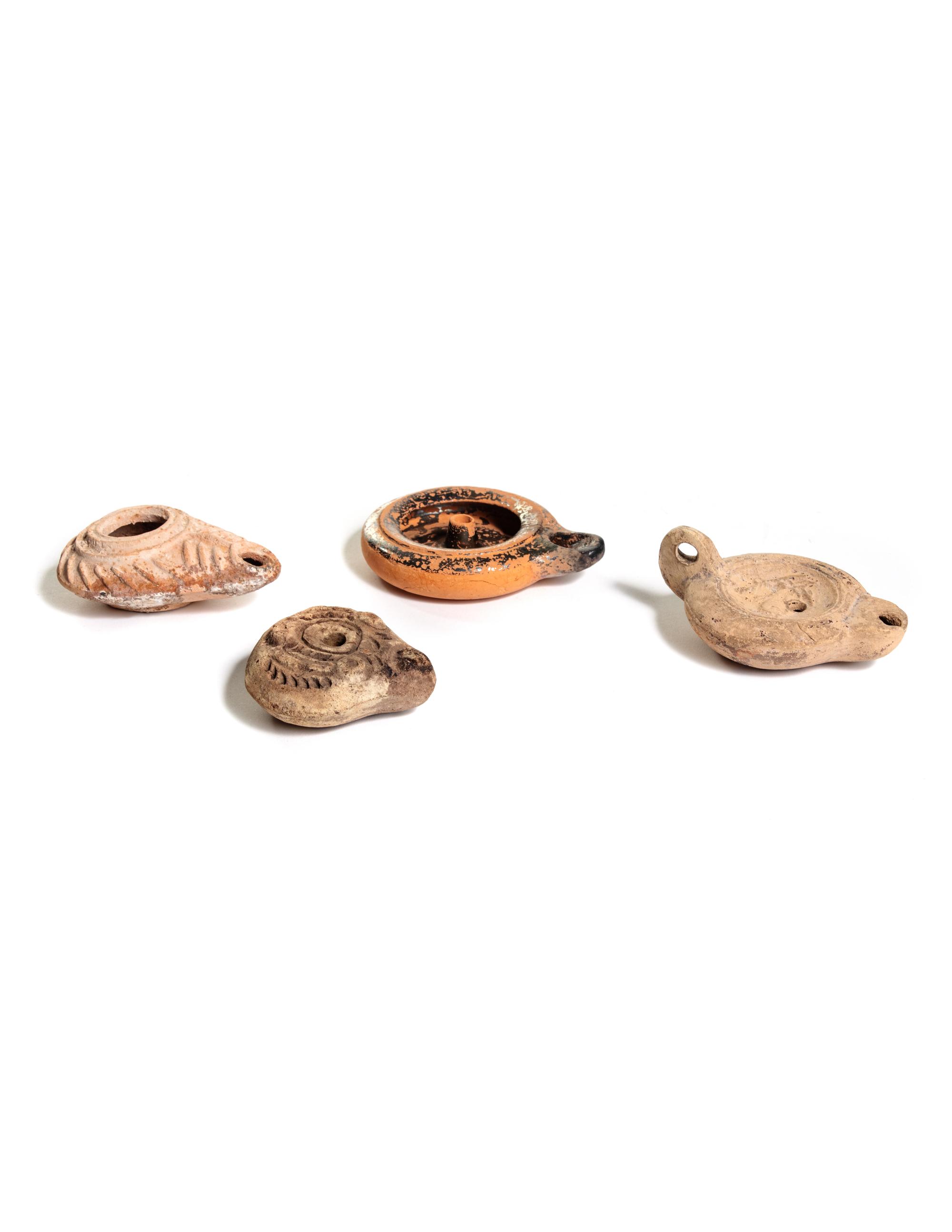 Four Roman Molded Terra Cotta Oil Lamps