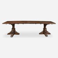 A Gothic Revival carved oak dining table composed of elements likely dating to the 17th century and later