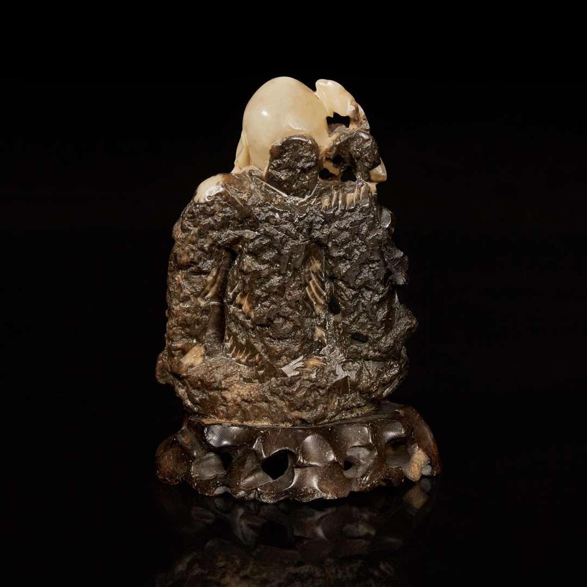 A Chinese carved beige and dark brown soapstone figure of Shoulao 棕灰壽山石雕壽老 19th/20th century ???????